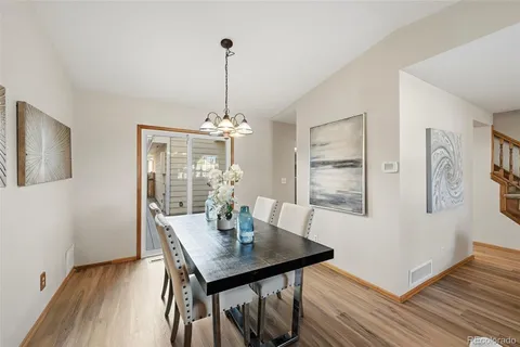 a view of a dining room with furniture window and wooden floor