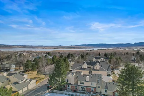 an aerial view of residential houses and trees in the background