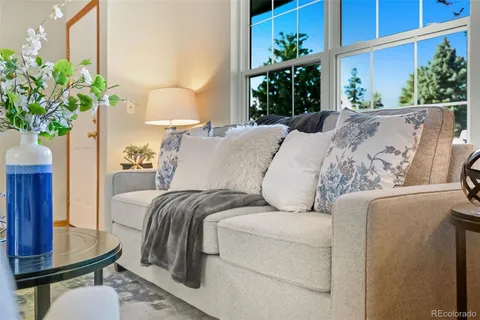 a bed sitting in a bedroom next to a window with potted plant