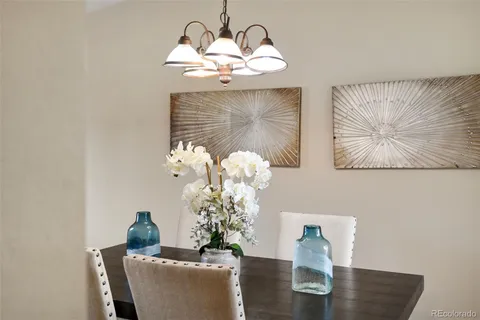 a view of a dining room with furniture and a chandelier