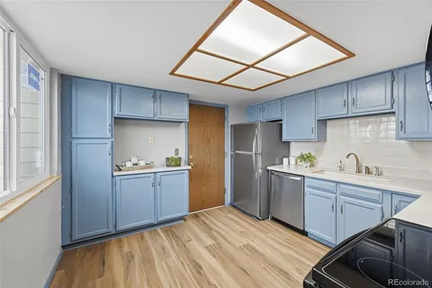 a kitchen with sink cabinets and wooden floor