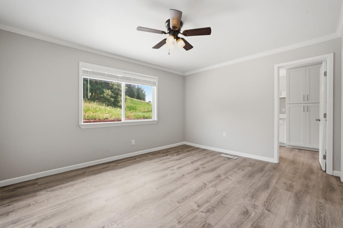 10867 Assisi Way Salinas, CA 93907 - Photo 12 of 35 wooden floor in an empty room with a window