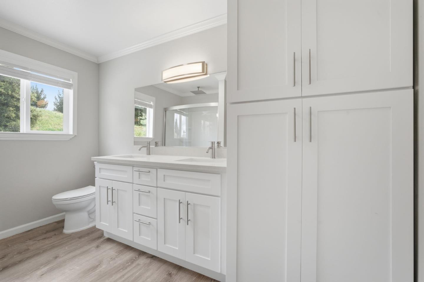 10867 Assisi Way Salinas, CA 93907 - Photo 14 of 35 a bathroom with a toilet a sink a mirror and a window
