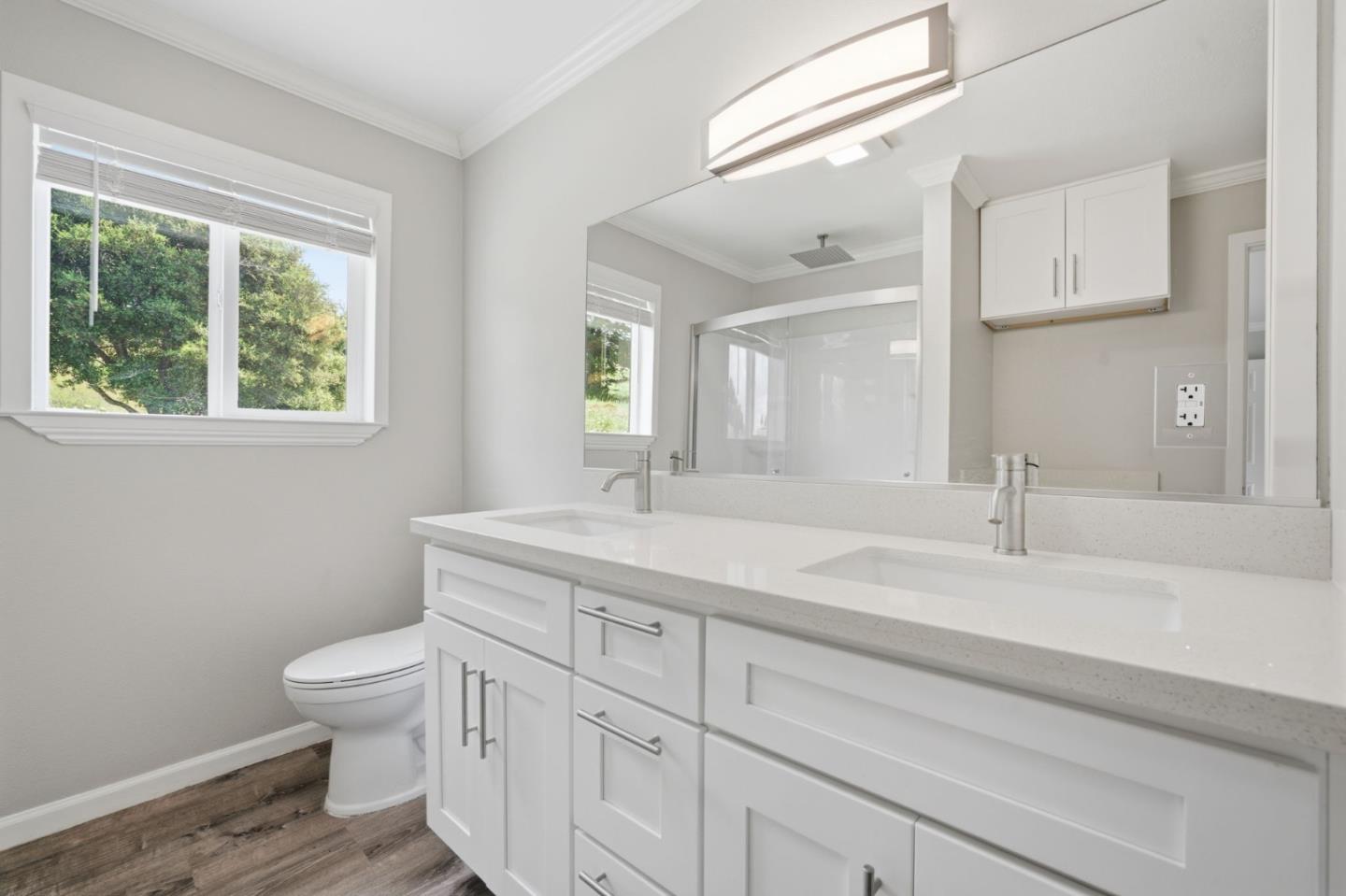 10867 Assisi Way Salinas, CA 93907 - Photo 15 of 35 a bathroom with a granite countertop sink a toilet and a window