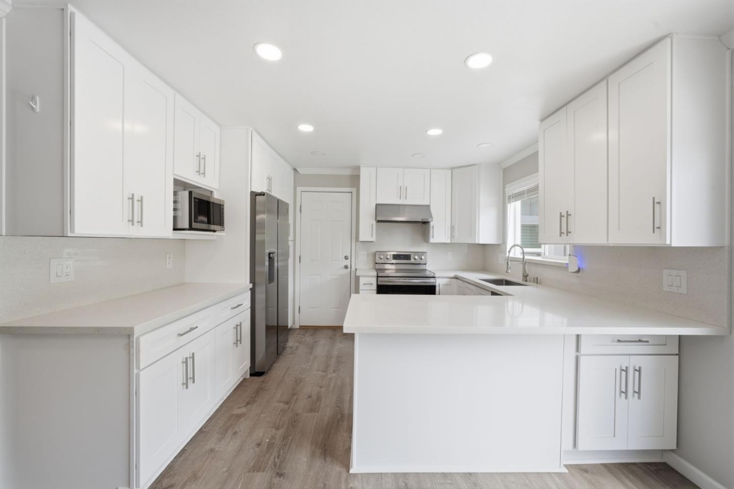 10867 Assisi Way Salinas, CA 93907 - Photo 33 of 35 a kitchen with a sink a counter top space stainless steel appliances and cabinets
