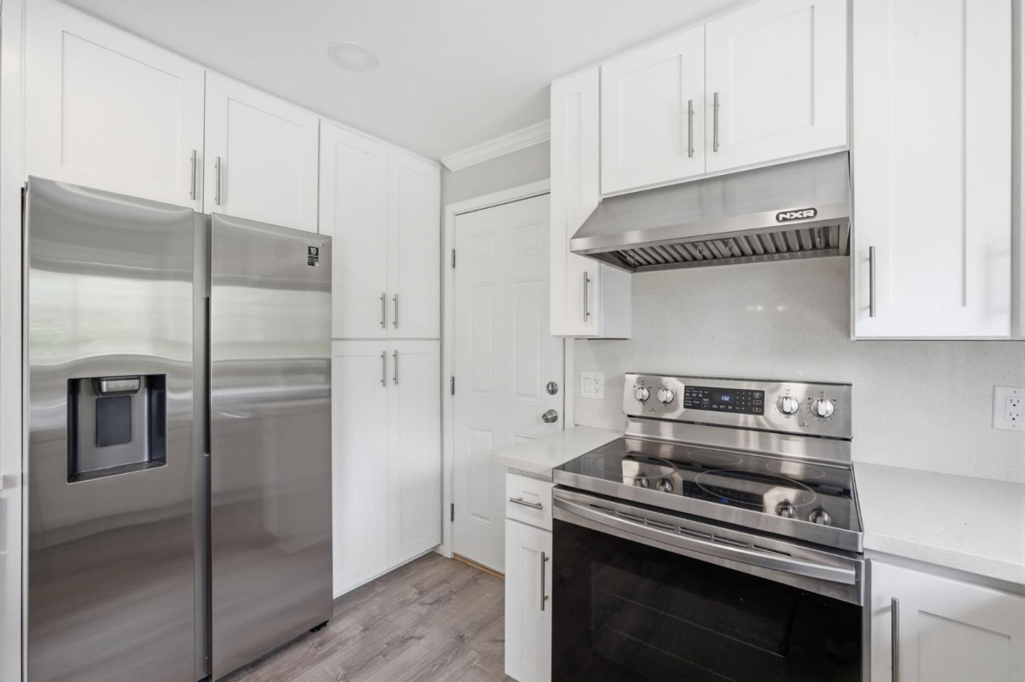 10867 Assisi Way Salinas, CA 93907 - Photo 7 of 35 a kitchen with stainless steel appliances and white cabinets