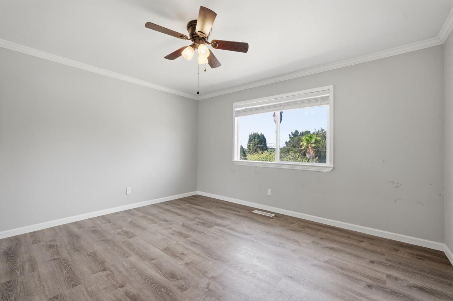 10867 Assisi Way Salinas, CA 93907 - Photo 9 of 35 wooden floor in an empty room with a window