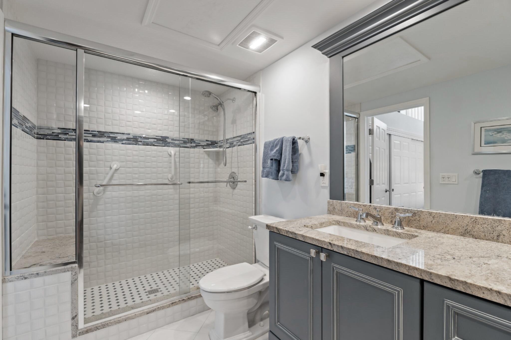 1801 South Us Highway, Unit 8D Jupiter, FL 33477 - Photo 17 of 36 a bathroom with a granite countertop sink toilet and shower