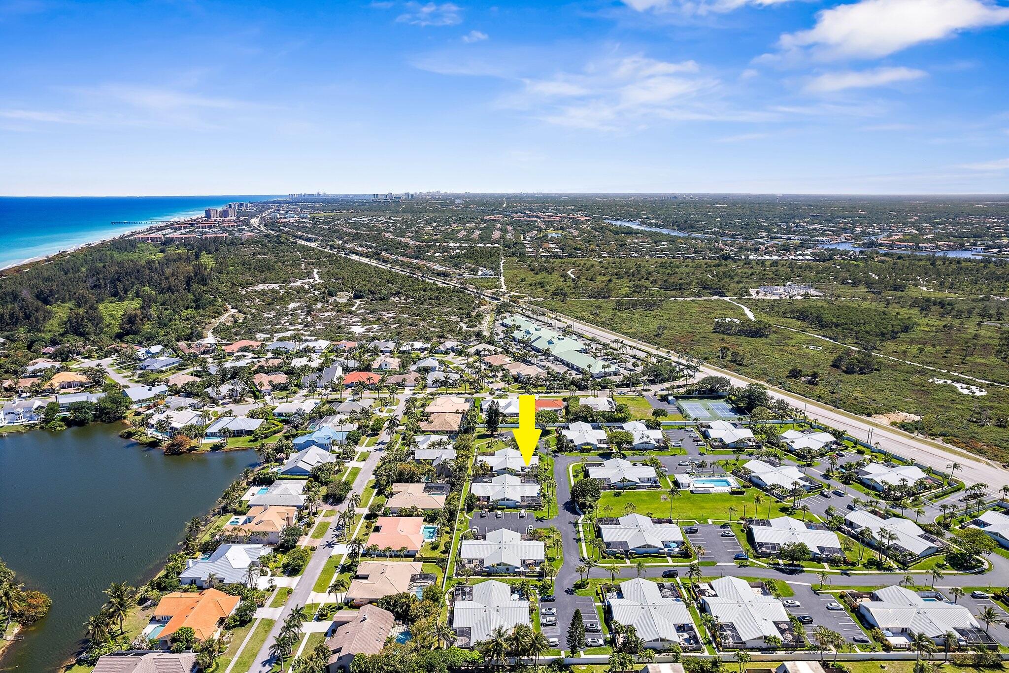 1801 South Us Highway, Unit 8D Jupiter, FL 33477 - Photo 27 of 36 an aerial view of residential building and lake