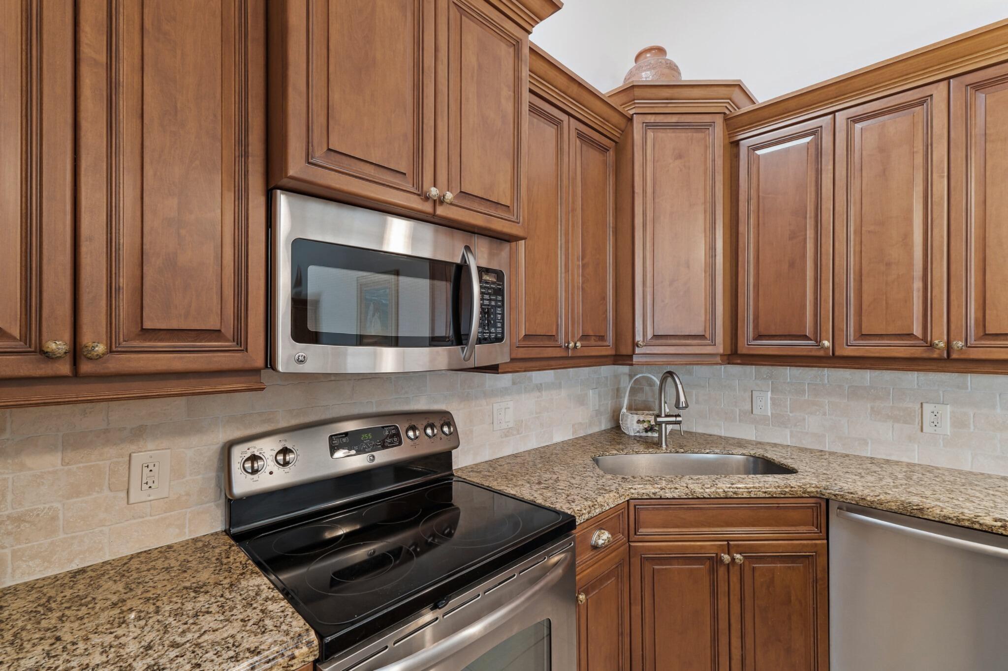 1801 South Us Highway, Unit 8D Jupiter, FL 33477 - Photo 9 of 36 a kitchen with a stove microwave and sink