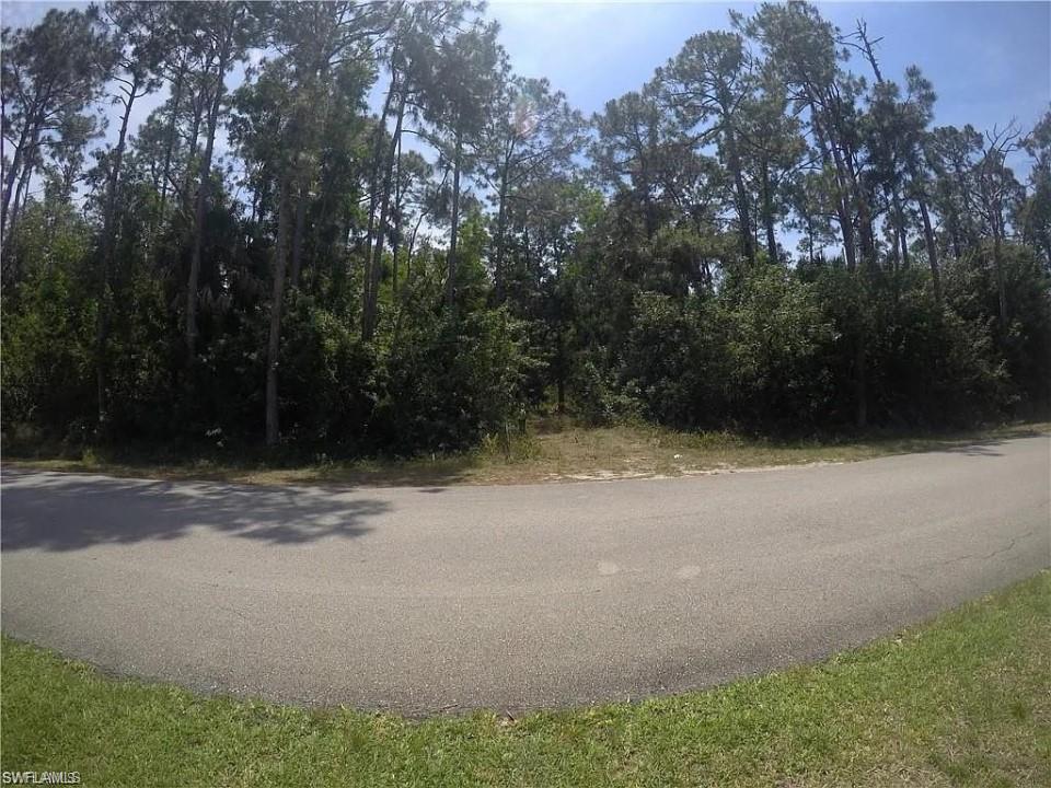 5700 Cedar Tree Lane Naples, FL 34116 - Photo 2 of 5 a view of a field with trees in the background