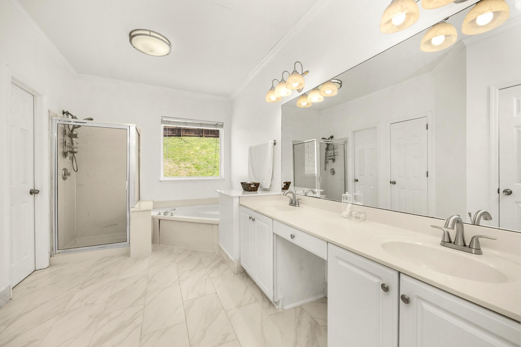 513 Cold Stream Place Nashville, TN 37221 - Photo 17 of 40 a spacious bathroom with a double vanity sink mirror and a bathtub