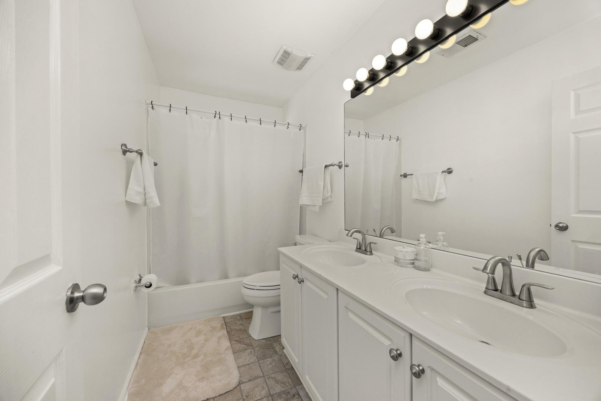 513 Cold Stream Place Nashville, TN 37221 - Photo 23 of 40 a bathroom with a double vanity sink toilet and shower