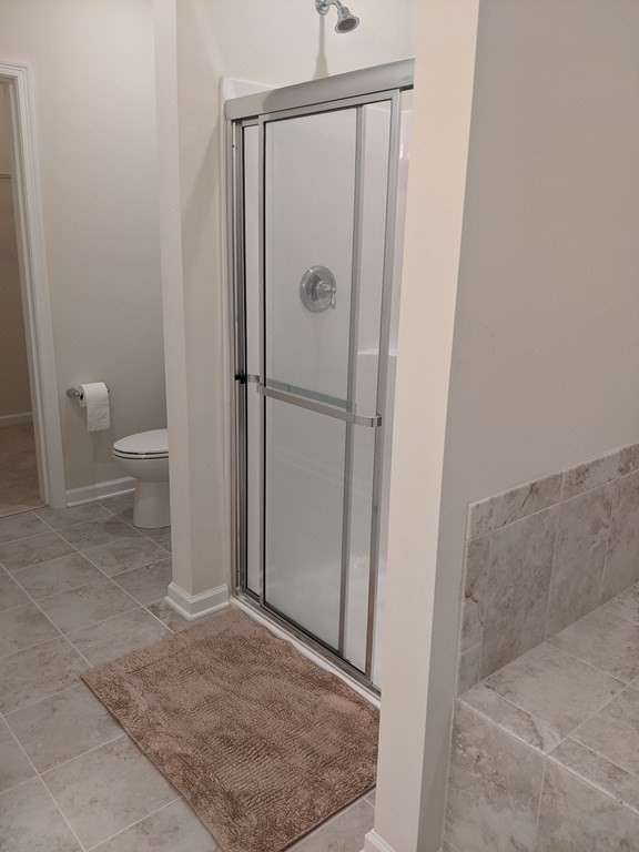 70 Trotter Road, Unit 312 Weymouth, MA 02190 - Photo 15 of 18 a bathroom with a granite countertop shower and a toilet