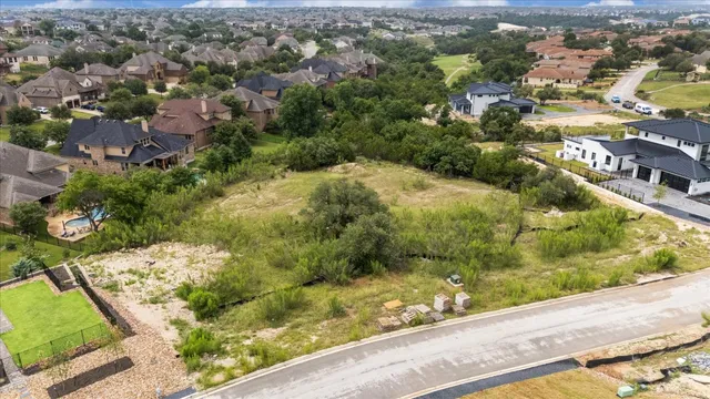 an aerial view of residential houses with city view