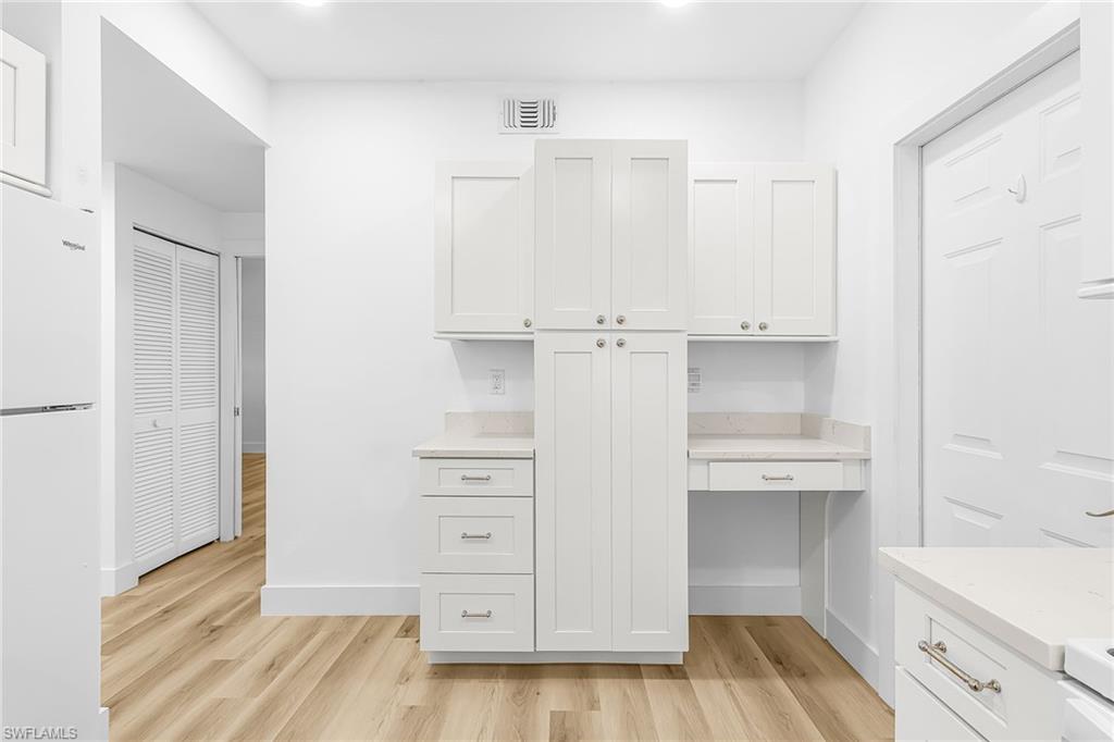 661 Windsor Square, Unit 101 Naples, FL 34104 - Photo 14 of 40 a view of cabinets and wooden floor