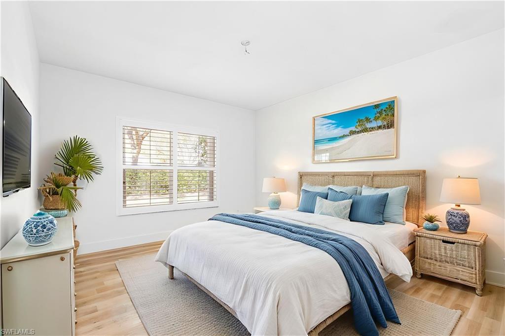 661 Windsor Square, Unit 101 Naples, FL 34104 - Photo 15 of 40 a bedroom with a bed and a window