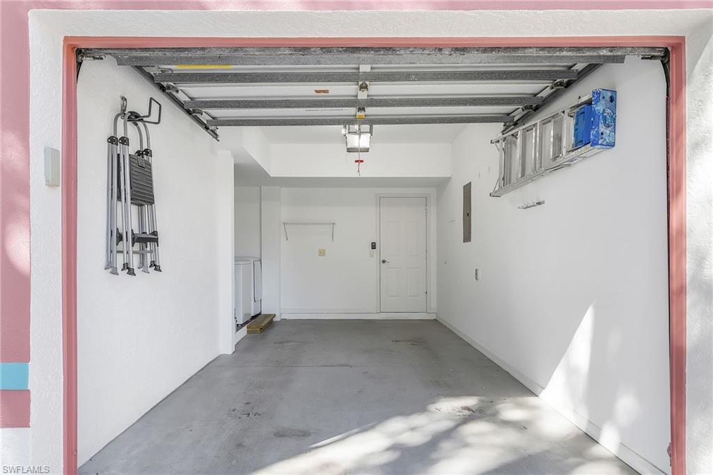 661 Windsor Square, Unit 101 Naples, FL 34104 - Photo 28 of 40 a view of a hallway with a white walls and stairs
