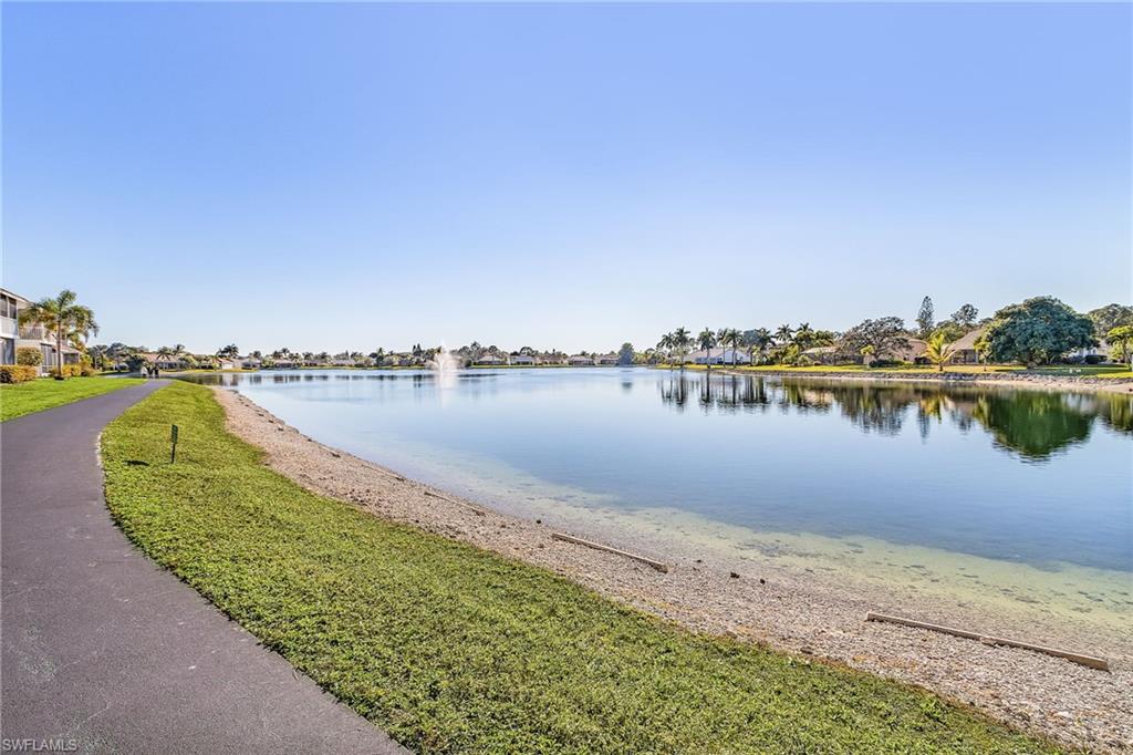 661 Windsor Square, Unit 101 Naples, FL 34104 - Photo 29 of 40 a view of a lake with houses in the back