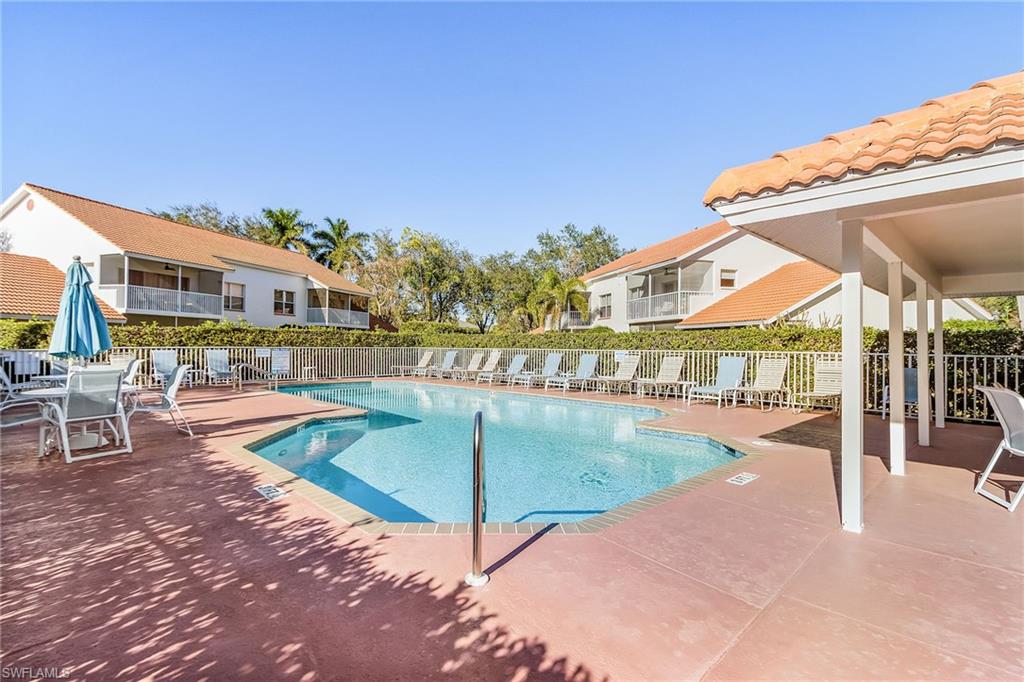 661 Windsor Square, Unit 101 Naples, FL 34104 - Photo 30 of 40 a view of a swimming pool with outdoor seating