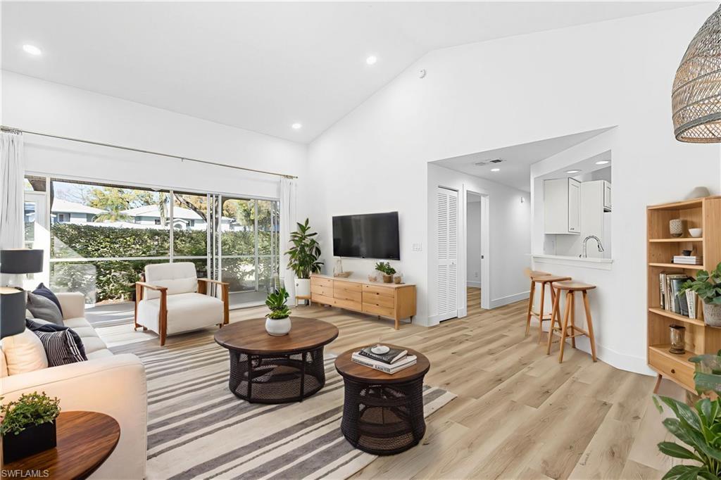 661 Windsor Square, Unit 101 Naples, FL 34104 - Photo 3 of 40 a living room with furniture and a flat screen tv