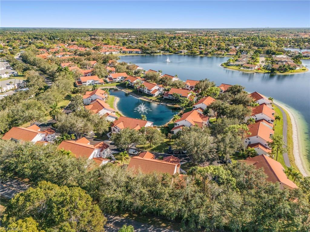 661 Windsor Square, Unit 101 Naples, FL 34104 - Photo 34 of 40 an aerial view of residential houses with outdoor space and lake view