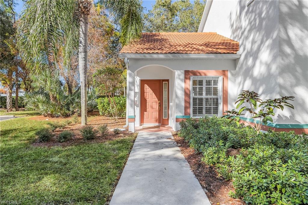 661 Windsor Square, Unit 101 Naples, FL 34104 - Photo 39 of 40 a front view of a house with garden