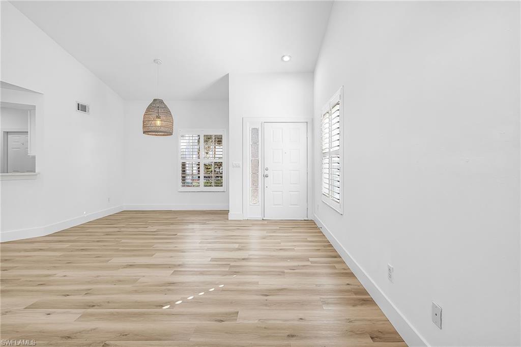 661 Windsor Square, Unit 101 Naples, FL 34104 - Photo 7 of 40 a view of an empty room and wooden floor