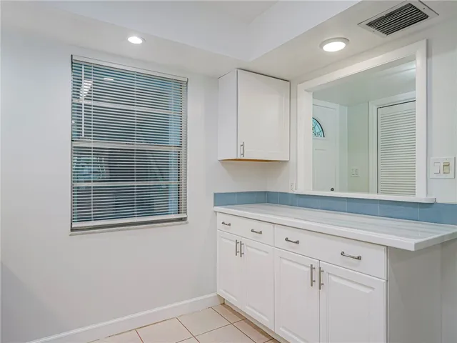 a view of a kitchen with white cabinets