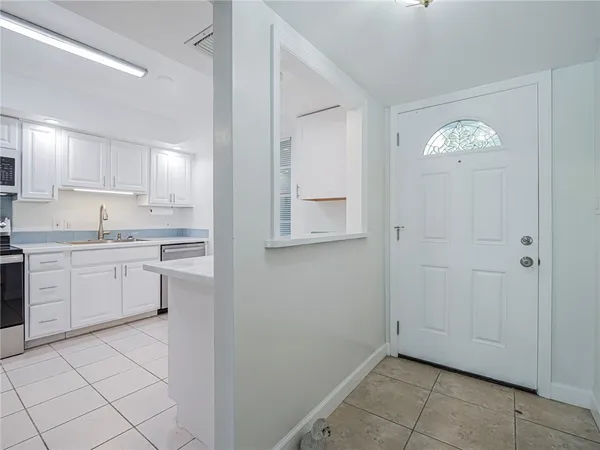 a kitchen with cabinets and window