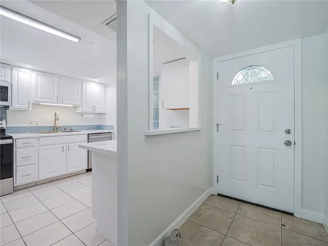 a kitchen with cabinets and window