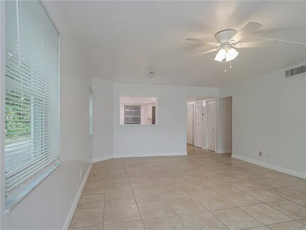 a view of an empty room with a window