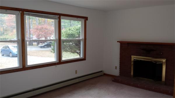 35 Mason Road Freetown, MA 02717 - Photo 4 of 16 a living room with a fireplace with a large window