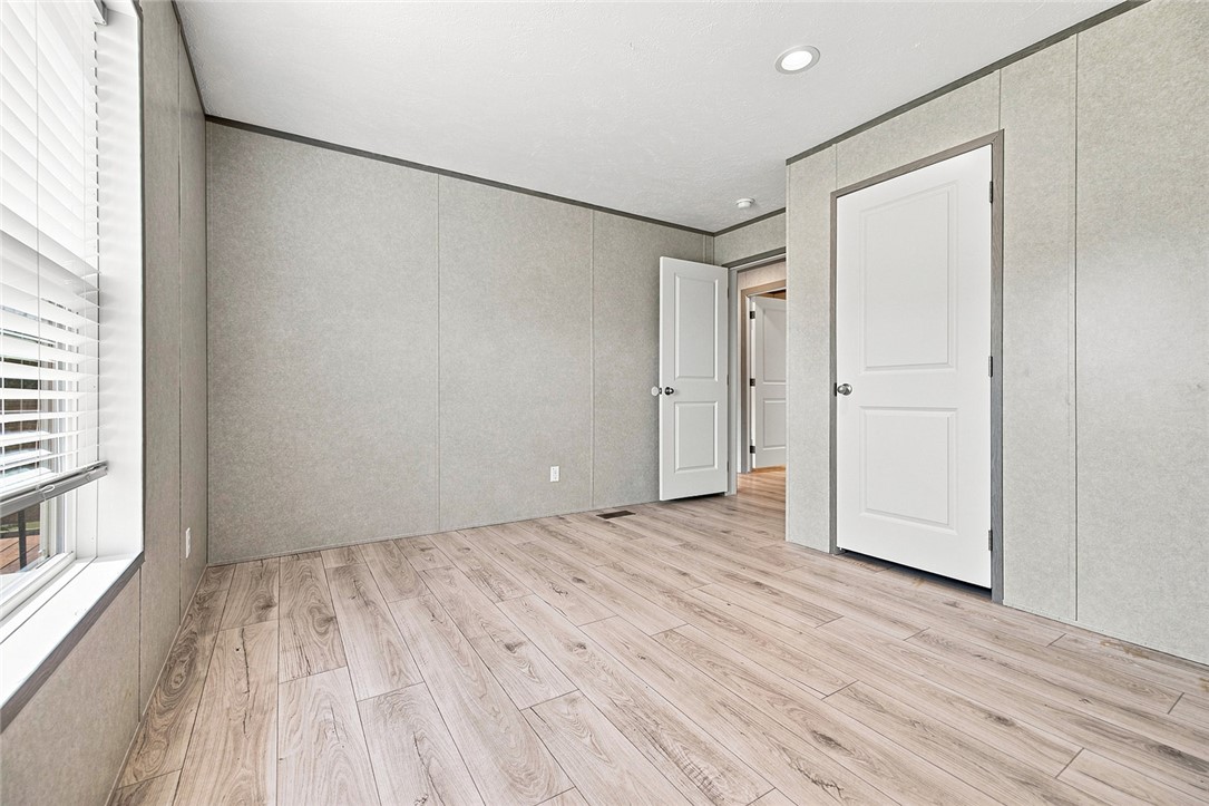 112 Purdy Road Iva, SC 29655 - Photo 19 of 33 Smooth wood-look flooring and clean neutral paneling define this versatile bedroom space.