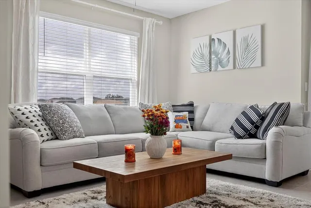 a front view of a house with a yard and a pond