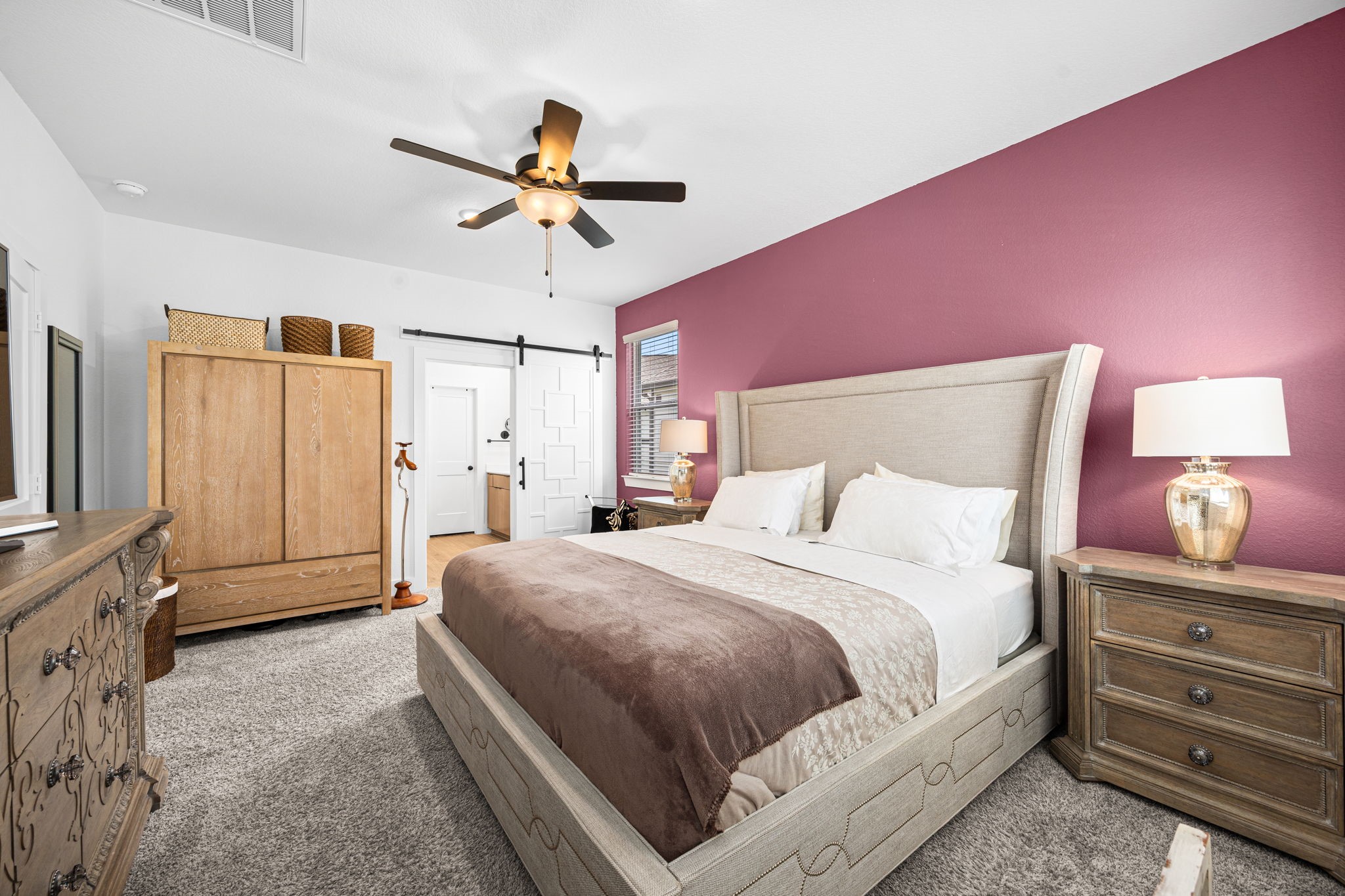 7618 Redbud Orchard Road Katy, TX 77493 - Photo 14 of 26 An upgraded barn door with detailed trim accents leads into the primary bath. Designer paint color here is reflected in Bedroom #3 as well.