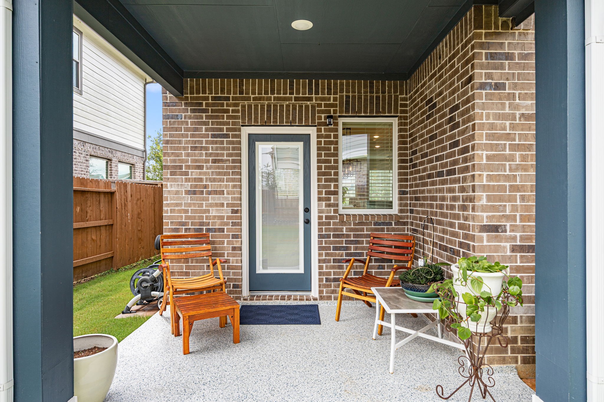 7618 Redbud Orchard Road Katy, TX 77493 - Photo 21 of 26 This covered back patio is one of 3 outdoor porches/patios at this home! It is ready and waiting for your morning coffee, BBQ grill, or lounging furniture. THe floor coating seen here is the same as you saw on the front porch, color-coordinated to match the home's exterior paint selections.