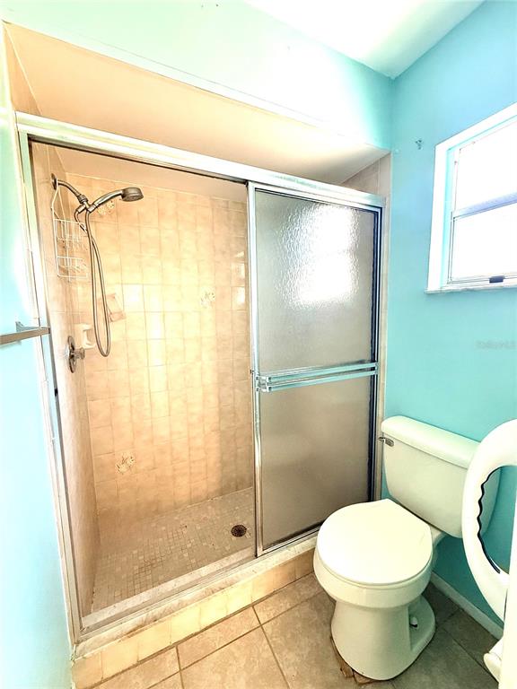 3410 Hartley Road Spring Hill, FL 34606 - Photo 12 of 29 a bathroom with a toilet and a shower