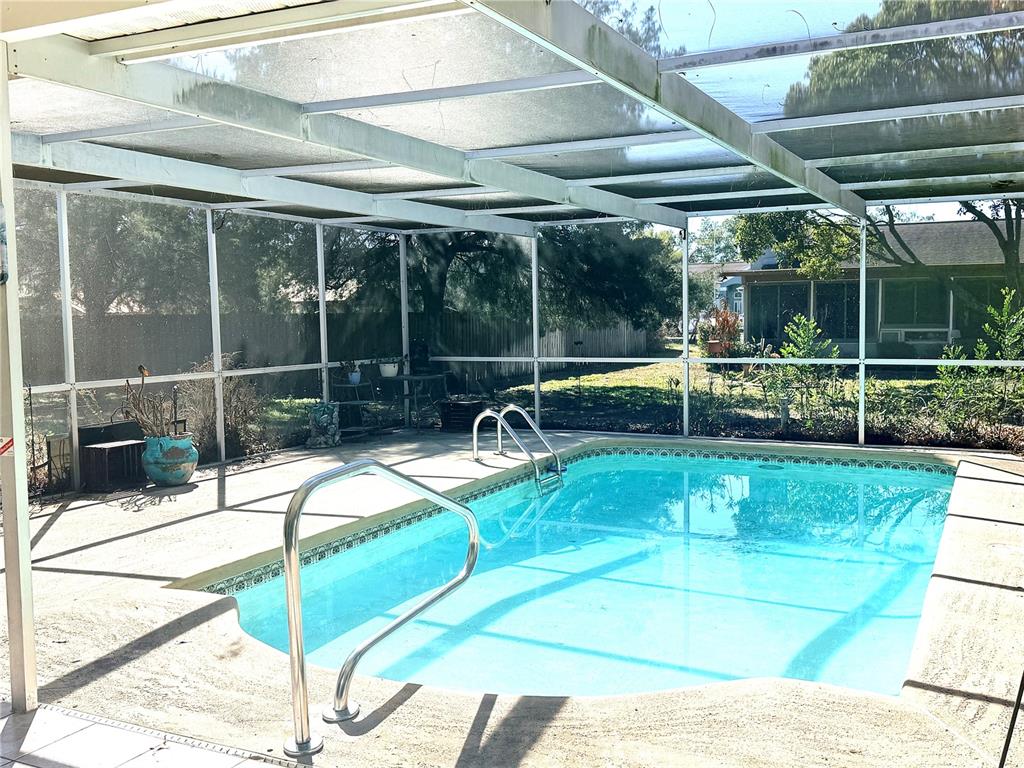 3410 Hartley Road Spring Hill, FL 34606 - Photo 13 of 29 a view of a swimming pool with a patio