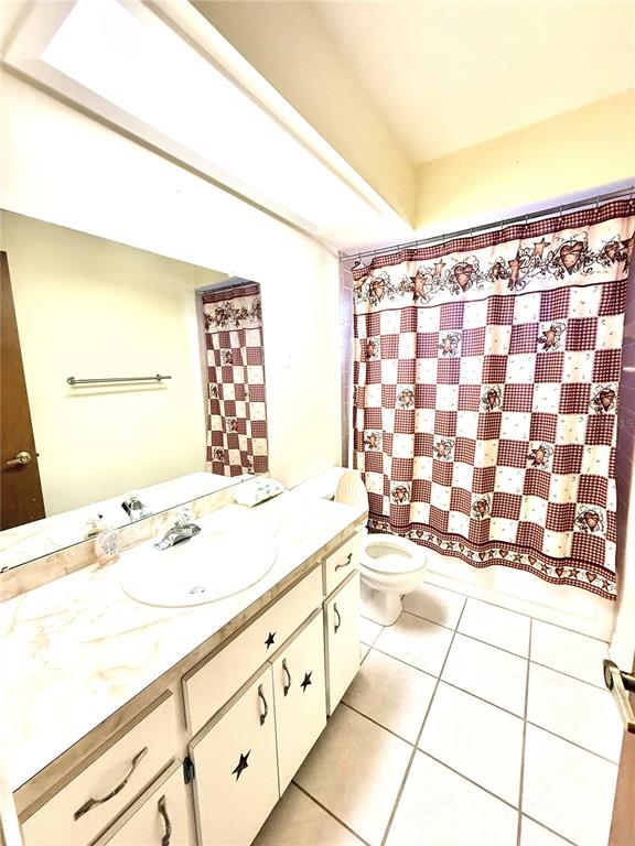 3410 Hartley Road Spring Hill, FL 34606 - Photo 14 of 29 a bathroom with a sink a toilet and a shower