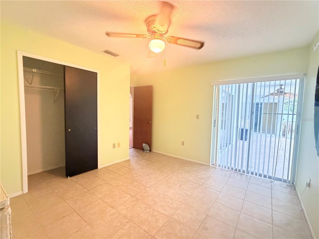 3410 Hartley Road Spring Hill, FL 34606 - Photo 18 of 29 a view of an empty room with a ceiling fan