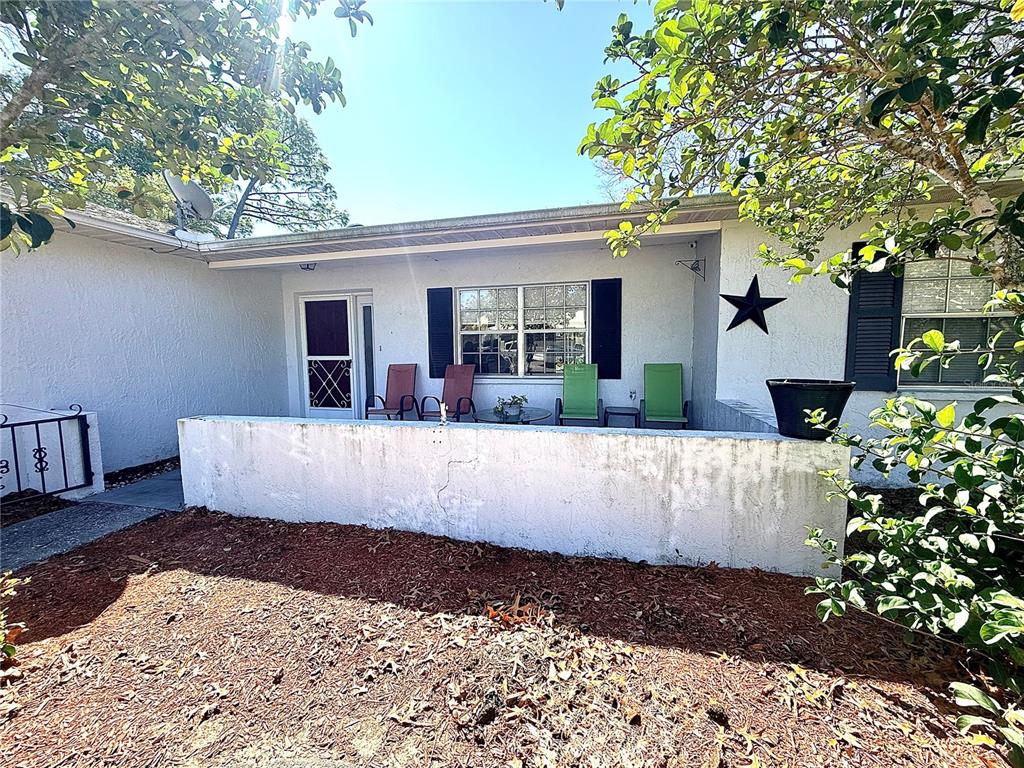 3410 Hartley Road Spring Hill, FL 34606 - Photo 2 of 29 a view of a white house with a large tree and a yard