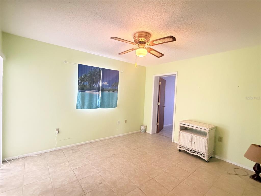 3410 Hartley Road Spring Hill, FL 34606 - Photo 22 of 29 a living room with a bed furniture and a window