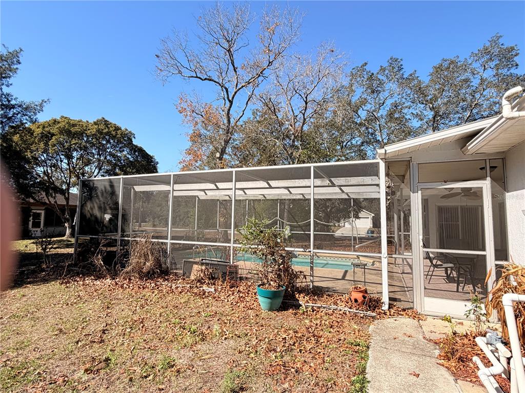 3410 Hartley Road Spring Hill, FL 34606 - Photo 27 of 29 a view of a backyard with wooden fence and floor