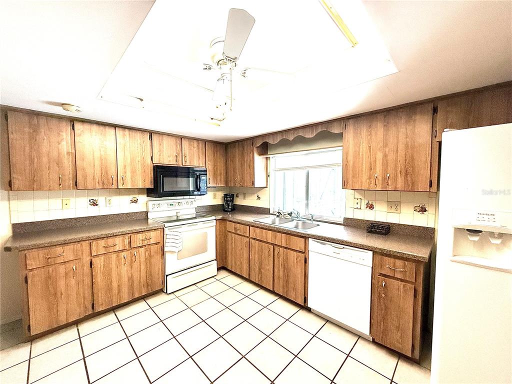 3410 Hartley Road Spring Hill, FL 34606 - Photo 3 of 29 a kitchen with granite countertop appliances cabinets and furniture
