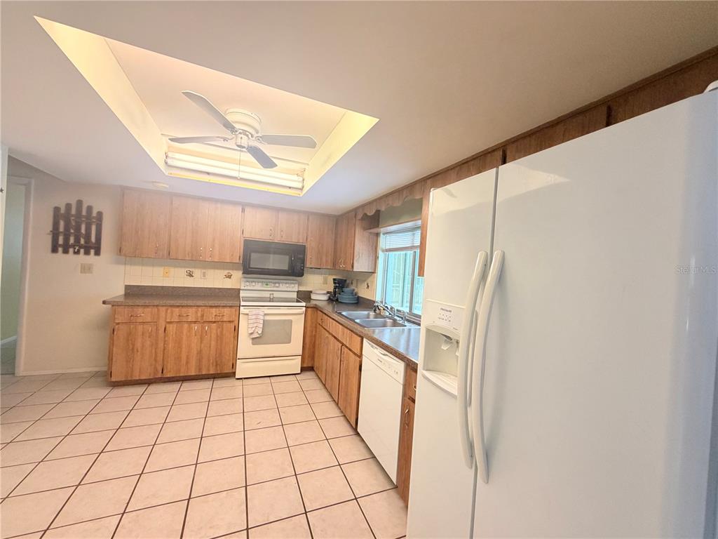 3410 Hartley Road Spring Hill, FL 34606 - Photo 4 of 29 a kitchen with stainless steel appliances granite countertop a sink counter space and cabinets