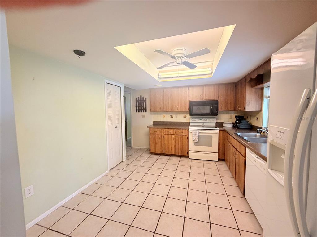 3410 Hartley Road Spring Hill, FL 34606 - Photo 5 of 29 a kitchen with stainless steel appliances a refrigerator sink and cabinets