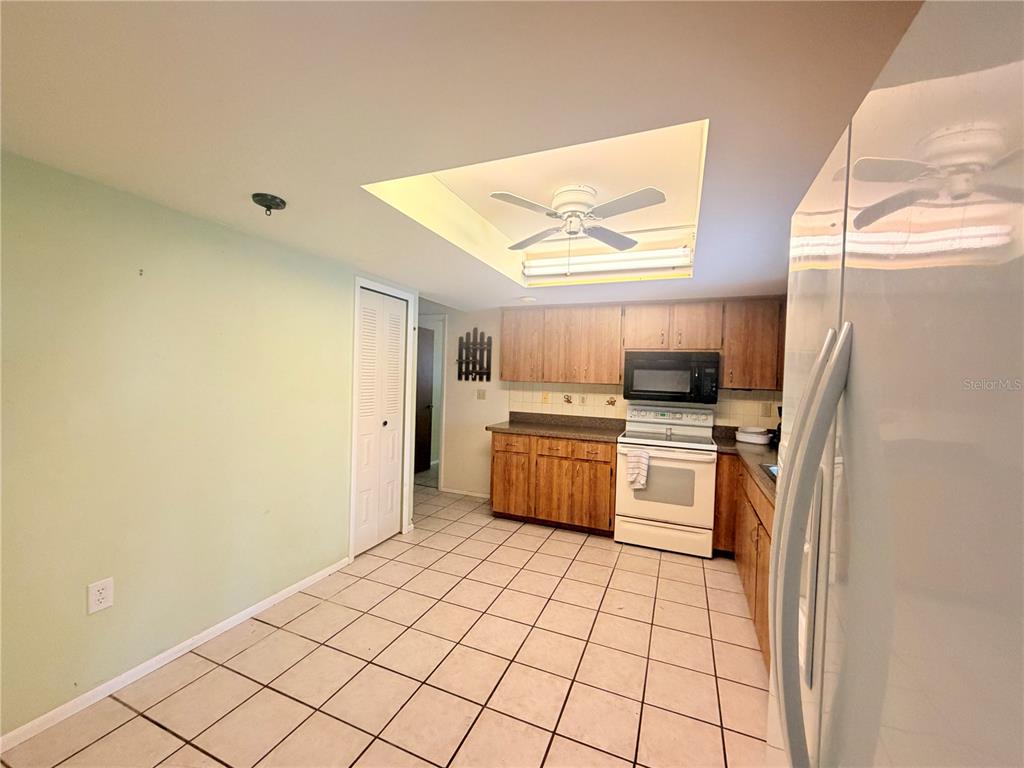 3410 Hartley Road Spring Hill, FL 34606 - Photo 6 of 29 a kitchen with a refrigerator a stove top oven and cabinets