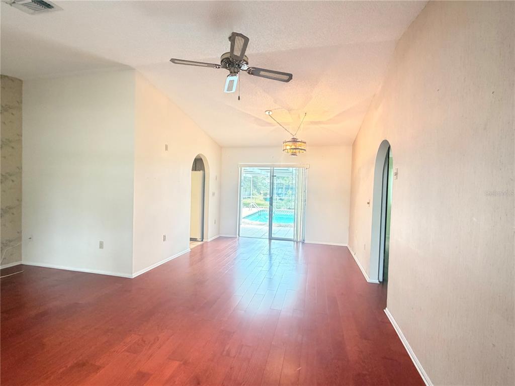 3410 Hartley Road Spring Hill, FL 34606 - Photo 8 of 29 a view of a room with wooden floor closet and windows