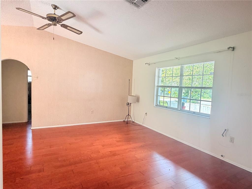 3410 Hartley Road Spring Hill, FL 34606 - Photo 10 of 29 wooden floor in an empty room with a window